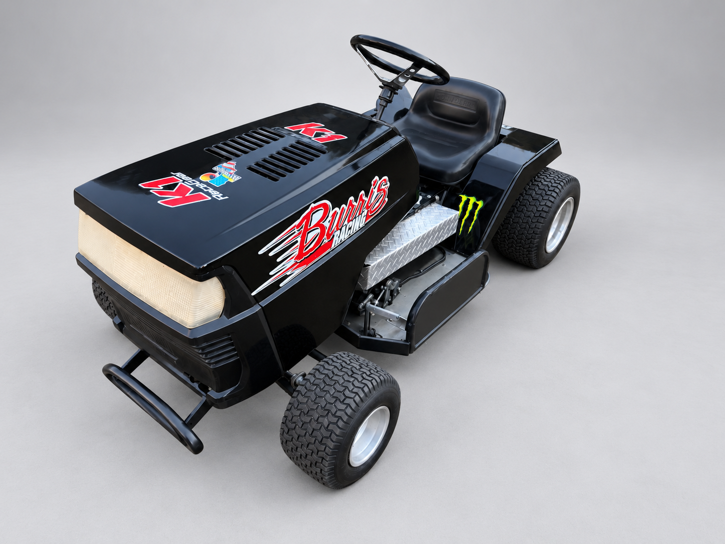 Black racing mower — studio reference showing bodywork, seating and wheels