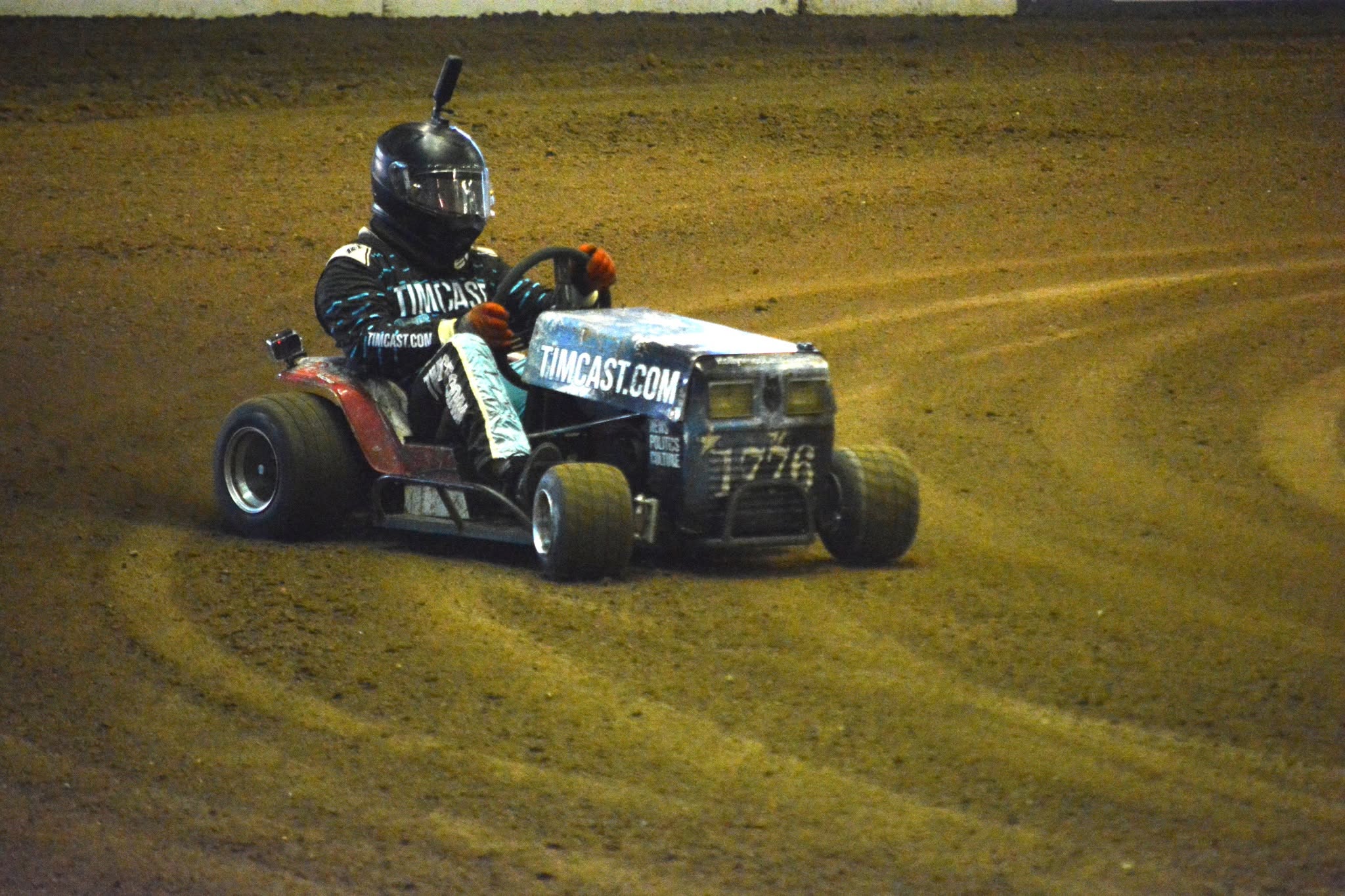 Britt Griffith racing a Timcast lawnmower on a dirt track