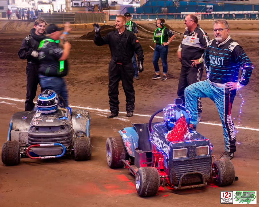 Britt beside his Timcast mower with fellow racers at the track